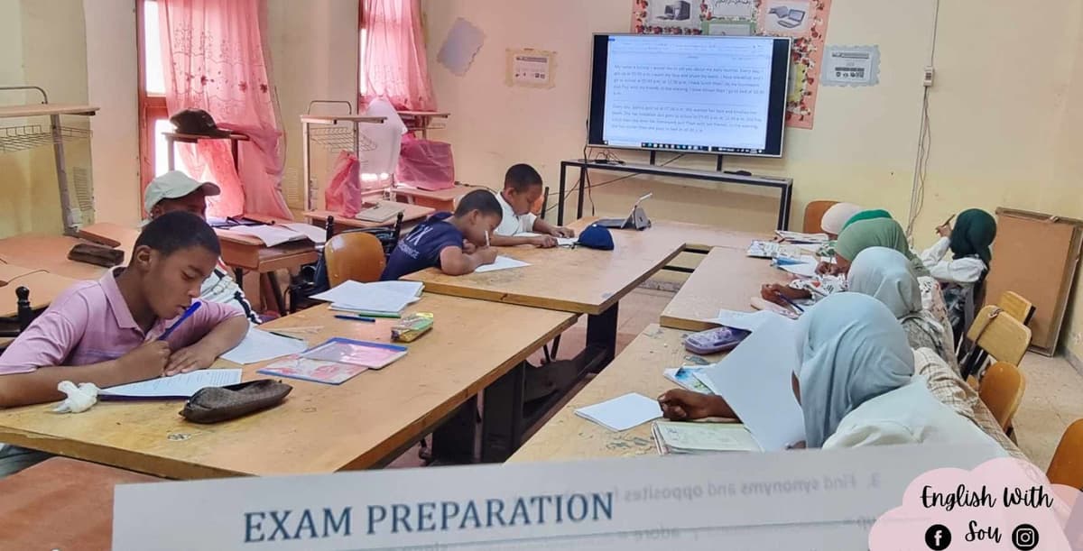 Teacher helping a student with a laptop